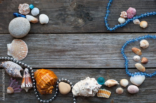 seashells and pebbles on the wooden table
