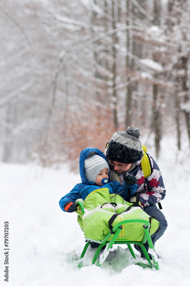 mother and son on sledge mother and son on sledge