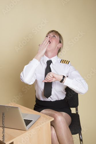 Tired female airline pilot wearing insignia of a captain photo