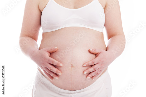 Close up of a pregnant belly, isolated on white background