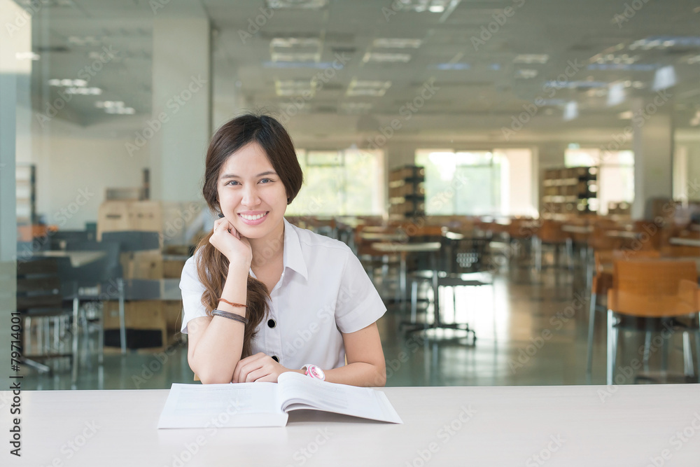 Asian student in uniform reading book at classroom Asian student in uniform reading book at classroom