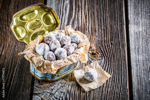 Sweet chocolate balls with powder milk in old box