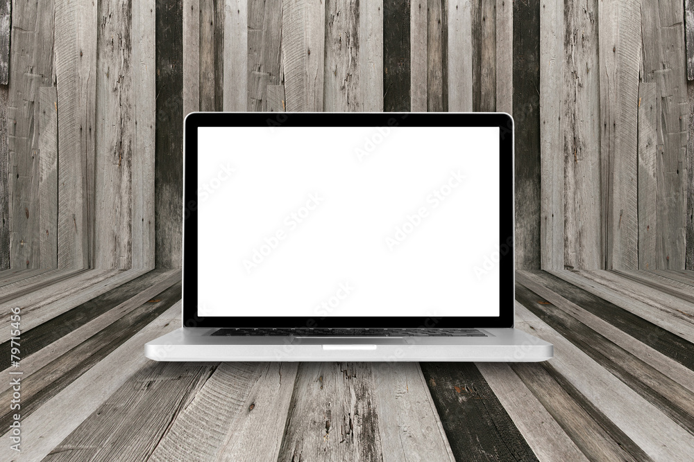 Silver laptop computer with blank screen on wooden floor Silver laptop computer with blank screen on wooden floor