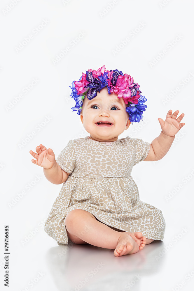 Beautiful little girl wearing a wreath, on a gray background Beautiful little girl wearing a wreath, on a gray background