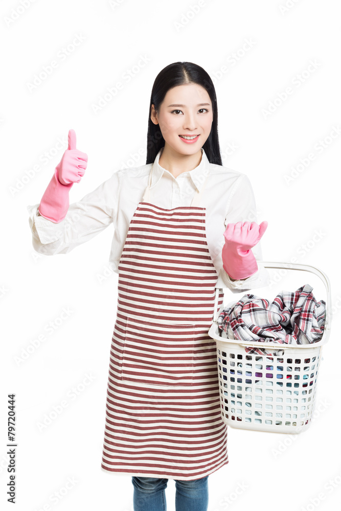 woman doing a housework holding basket of laundry woman doing a housework holding basket of laundry