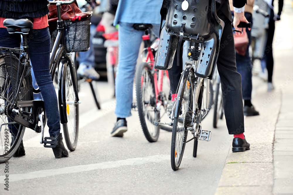 Fototapeta premium Commuters on bikes waiting for green light