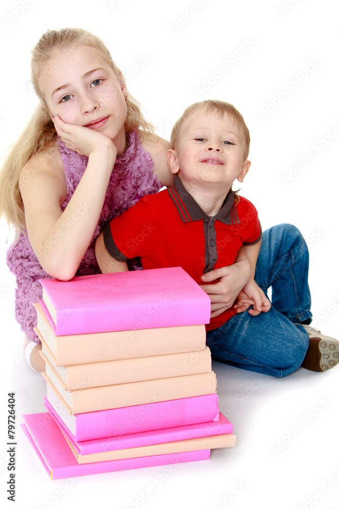 sister and brother sitting on the floor next to books sister and brother sitting on the floor next to books