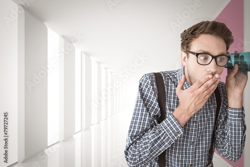 Composite image of geeky businessman eavesdropping with cup photo