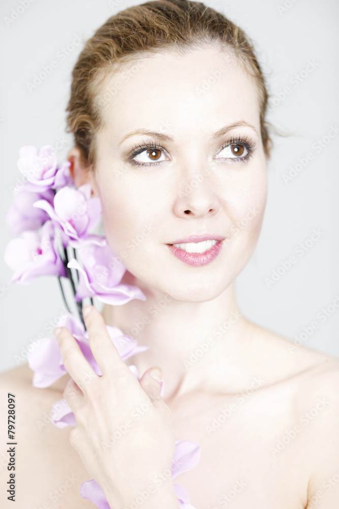Fototapeta premium Woman holding up Orchids