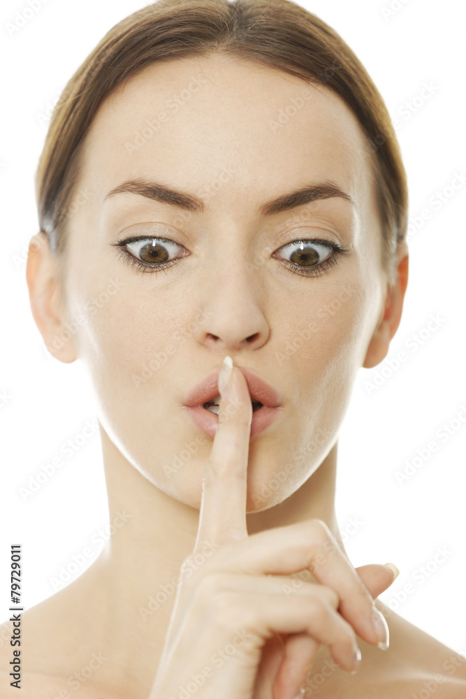 Woman holding her finger over her lips Woman holding her finger over her lips