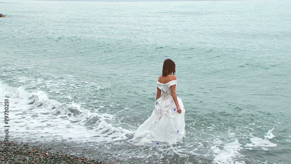 Beautiful Woman In White Dress Walking Into Sea Beautiful Woman In White Dress Walking Into Sea