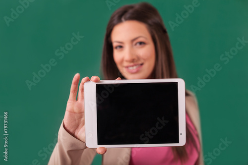 Beautiful woman showing a tablet