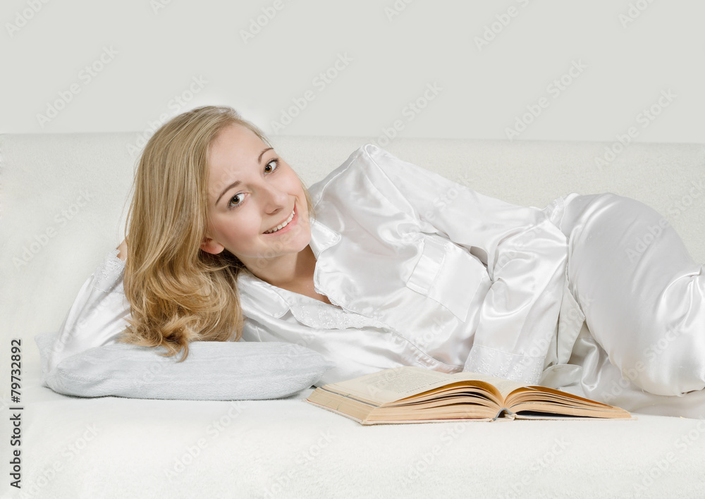 Young woman reading a book in bed Young woman reading a book in bed