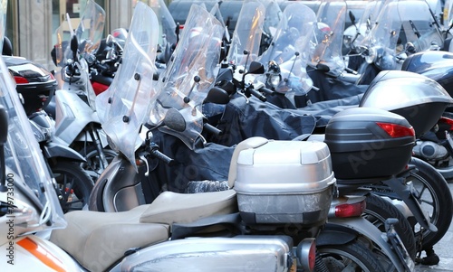 scooters and mopeds with winter windshield parked photo
