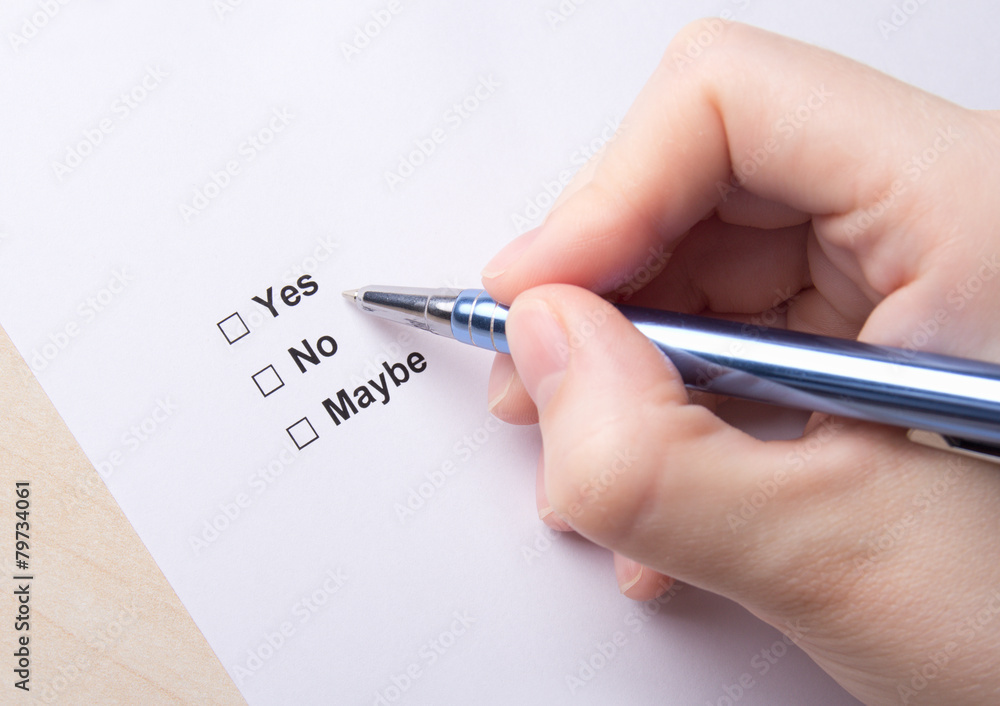 female hand filling survey with yes, no, maybe answers female hand filling survey with yes, no, maybe answers
