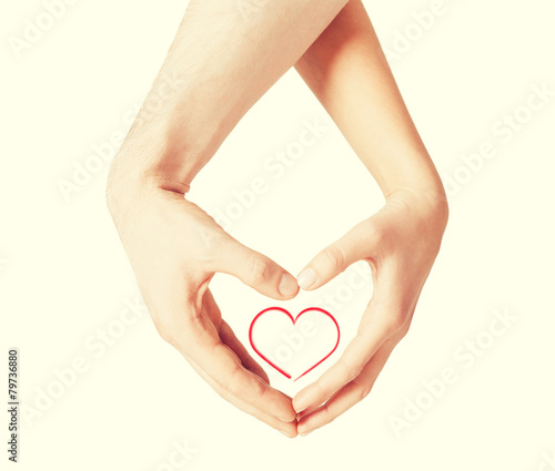 woman and man hands showing heart shape