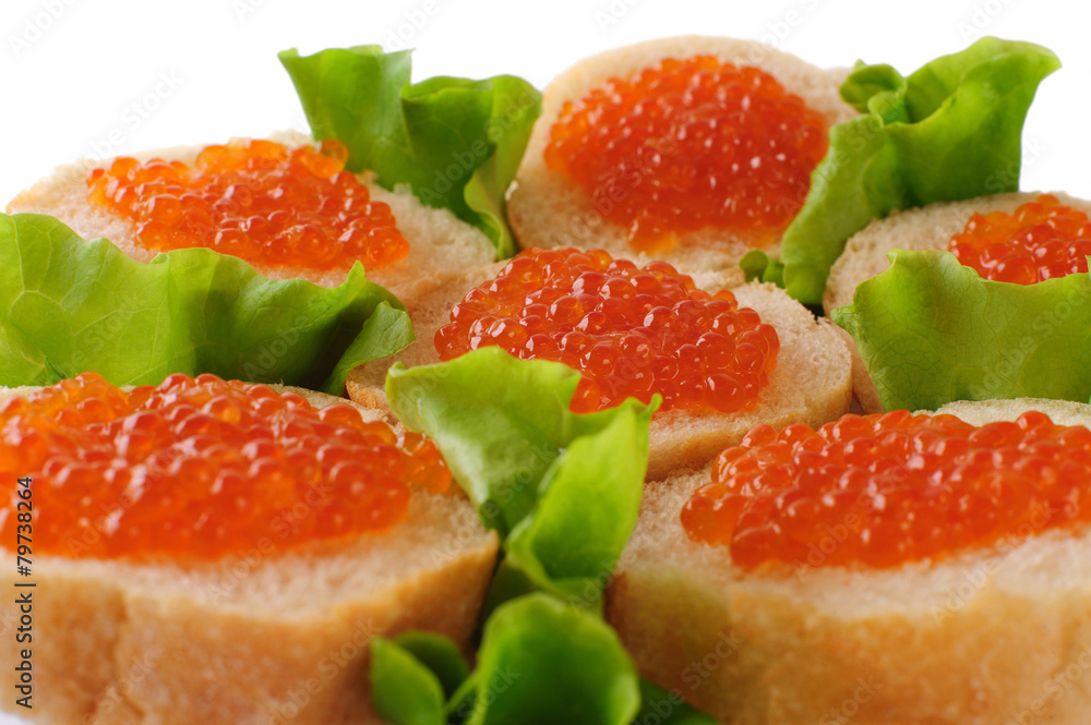 Sandwiches with red caviar and green lettuce.