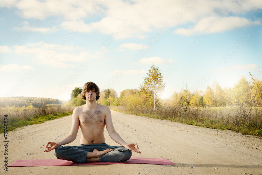 man practices asanas on yoga in harmony with nature