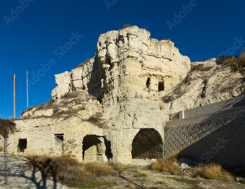 Village with  caves built into rock photo