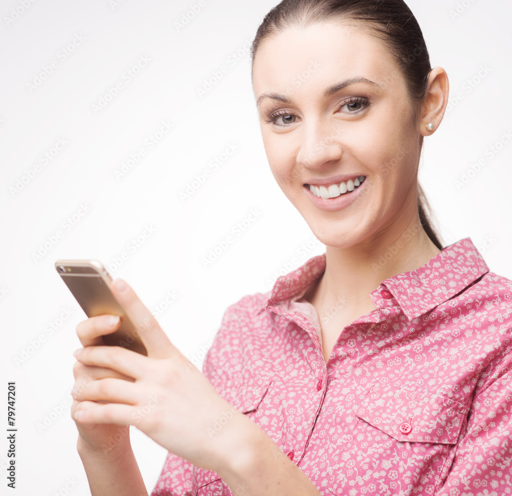Smiling woman using a mobile phone Smiling woman using a mobile phone