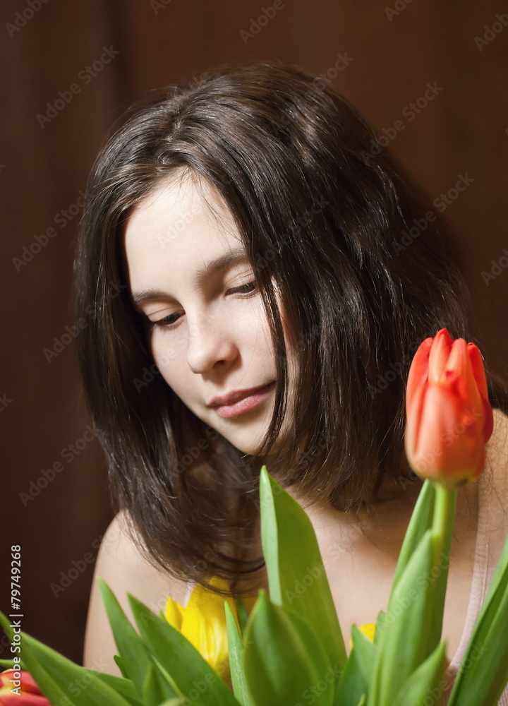 Naklejka premium Young girl with tulips.