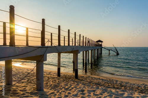 Beautiful sunset at tropical beach with jetty © Mohamad Zaki