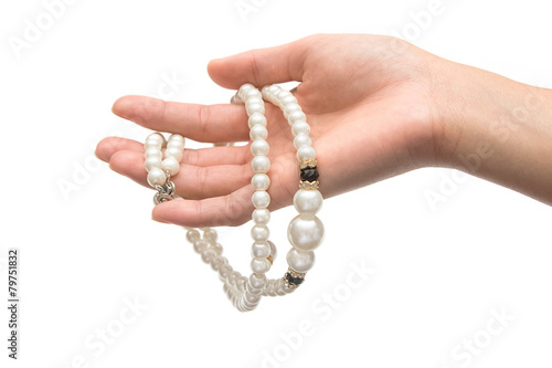 Beautiful pearl necklace on woman hand