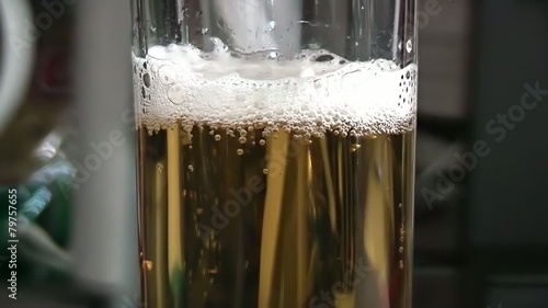 Pouring light beer into glass.
