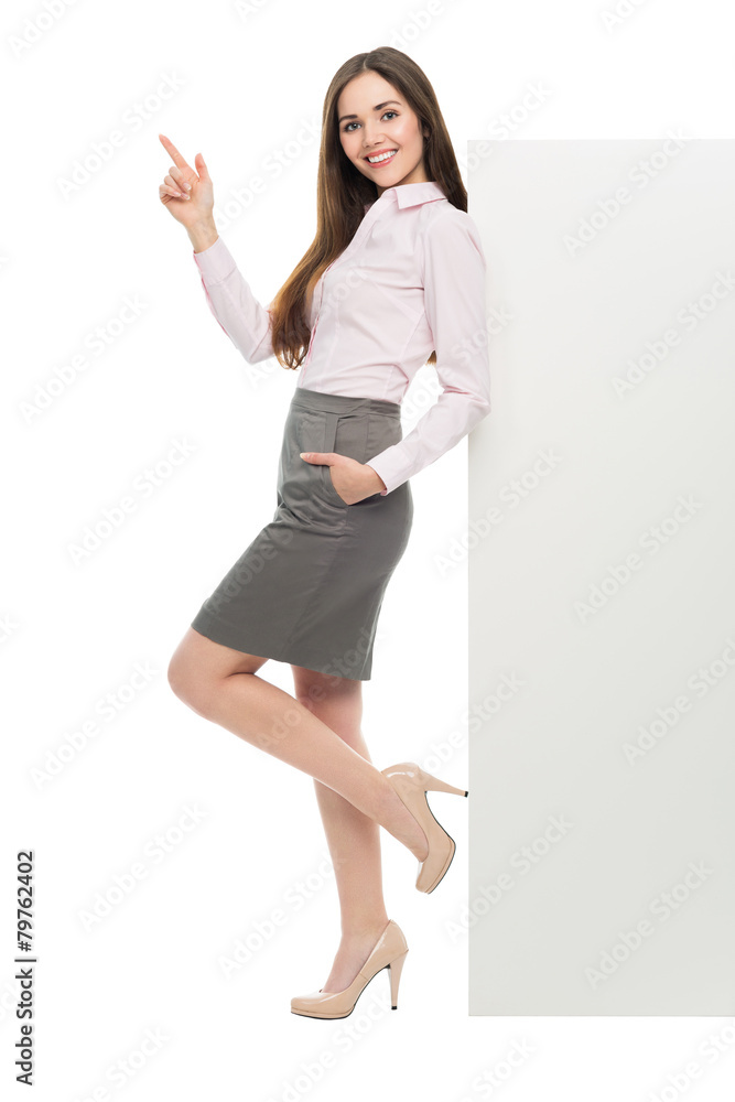 Beautiful woman leaning against big white poster Beautiful woman leaning against big white poster