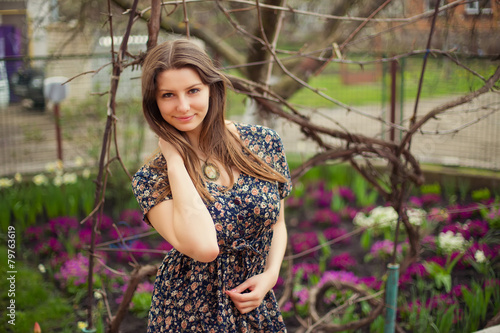 Portrait of young woman in old vintage dress in garden, prak in