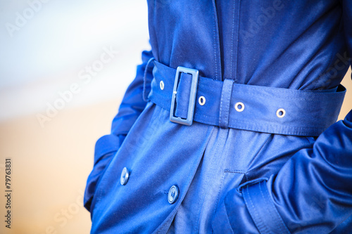 Female fashion. Closeup blue coat wit belt photo