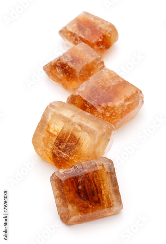 Brown caramelized lump cane sugar cube isolated on white backgro