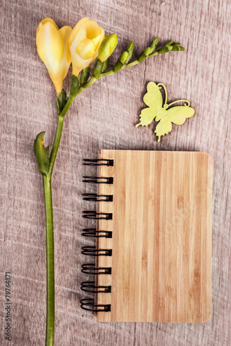 Eco-friendly notebook on the wooden table with flower