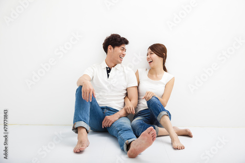 Happy Young asian Couple Sitting On Floor