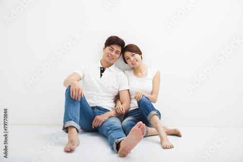 Happy Young Couple Sitting On Floor