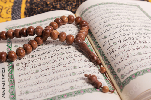 Tasbih with the Quran as a background photo