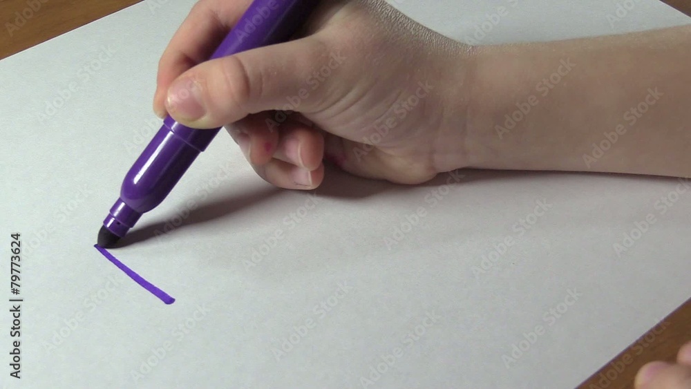 The child learns to write the word MOTHER. Close-up. The child learns to write the word MOTHER. Close-up.