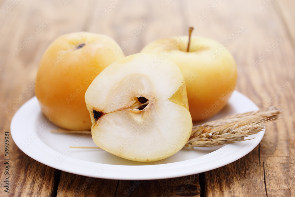 apples on a plate on a board apples on a plate on a board