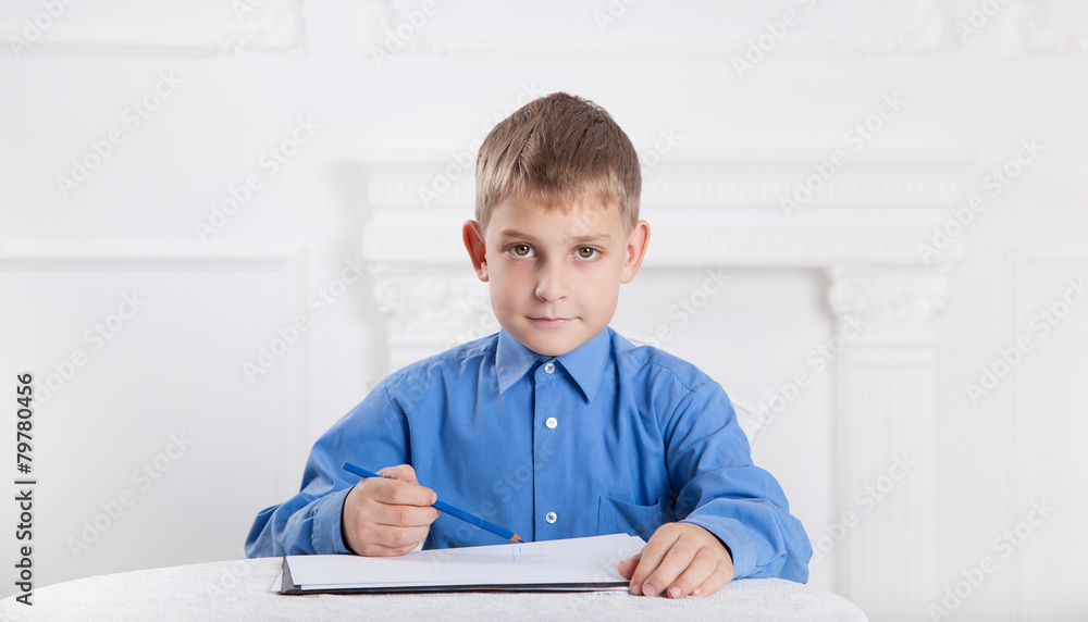 beautiful, caucasian boy draws a pencil on the album 2 beautiful, caucasian boy draws a pencil on the album 2