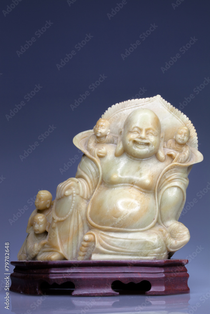 stone statue of Buddha, with blue background