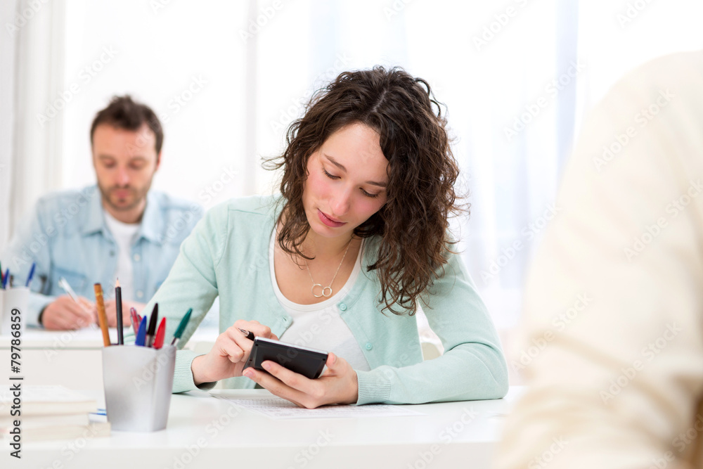 Young attractive student taking mathematics exams Young attractive student taking mathematics exams