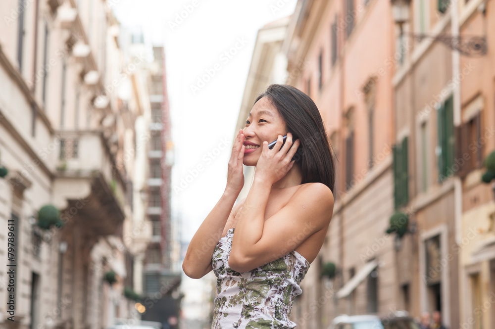 Young beautiful asian woman smiling using mobile phone spring ur