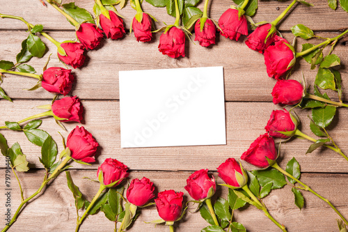 Roses arranged on old wooden background