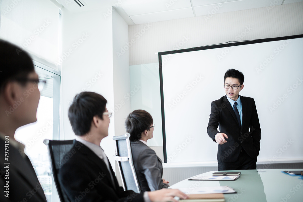 businessman giving a presentation to his colleagues businessman giving a presentation to his colleagues