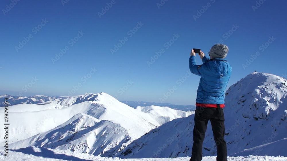 Young woman uses a smartphone to video a beautiful view