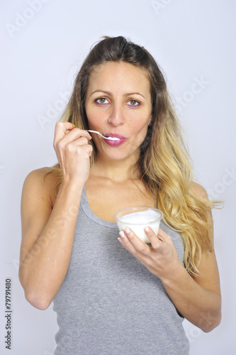 sexy girl with spoon eating cream yogurt healthy diet