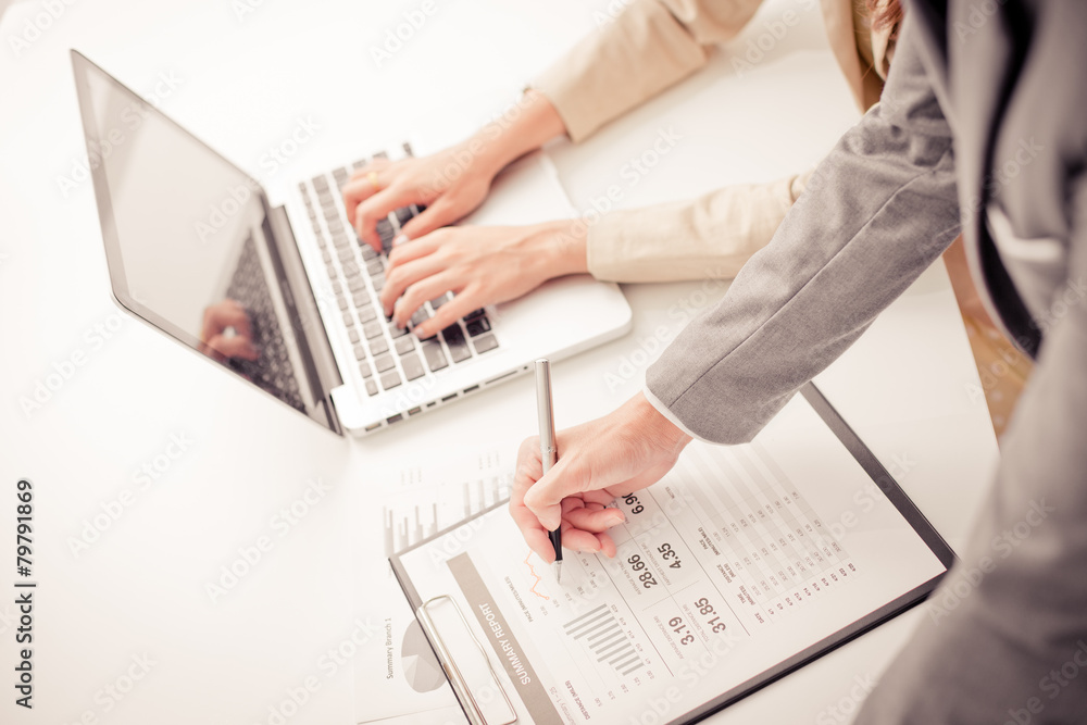 Business people discussing the charts and graphs showing the res Business people discussing the charts and graphs showing the res