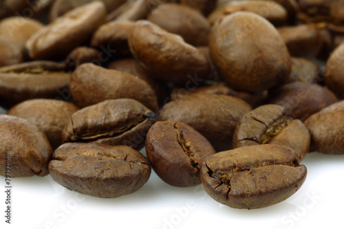 bunch of fresh coffee beans on a white background