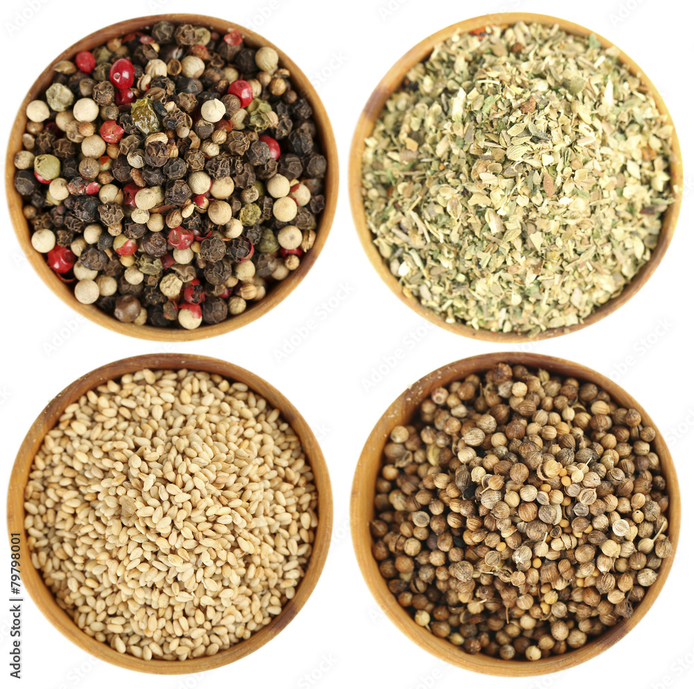 Fototapeta premium Different spices in bowls isolated on white
