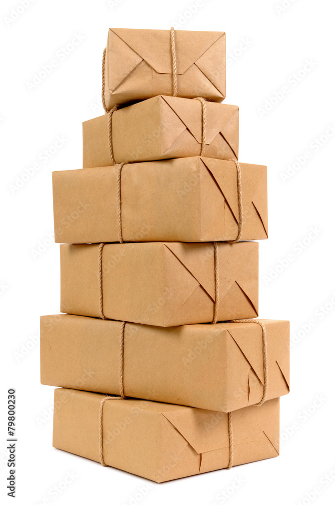 Tall stack or pile of several various brown paper package or